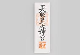 A rectangular wooden ofuda covered in paper, which has black calligraphy describing an Ise Faith shrine and a scarlet stamp bearing a shrine's name.